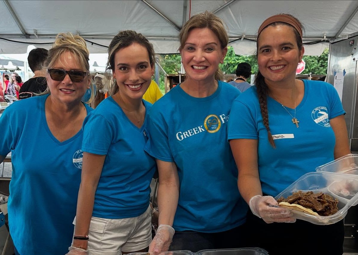 Smiling volunteers in matching shirts at a parish event